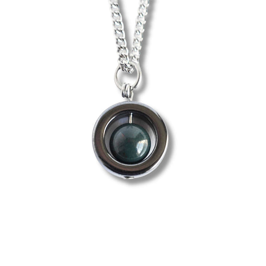 Silver necklace with a round pendant on a white background