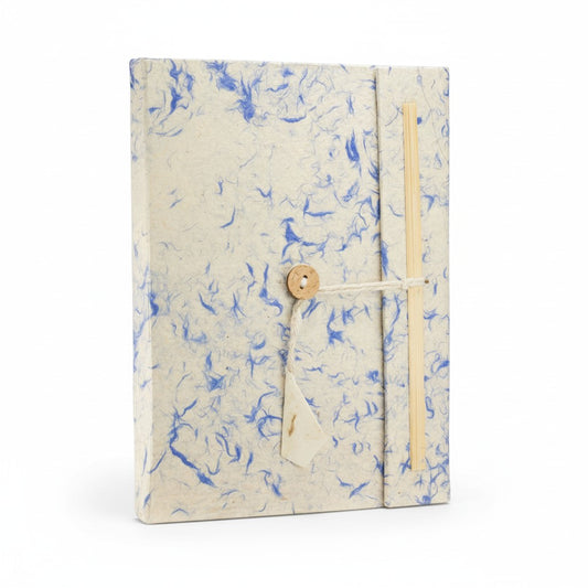 Notebook with blue abstract pattern and wooden button on a white background