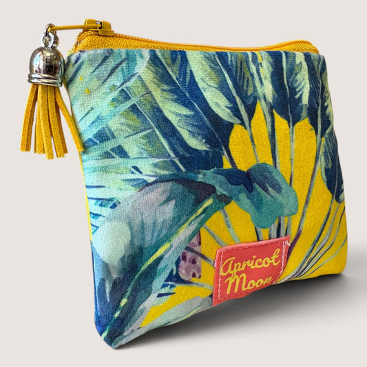 Palm Springs velvet purse angled to show the Apricot Moon label, with a yellow zip and yellow suede tassel with a silver cap