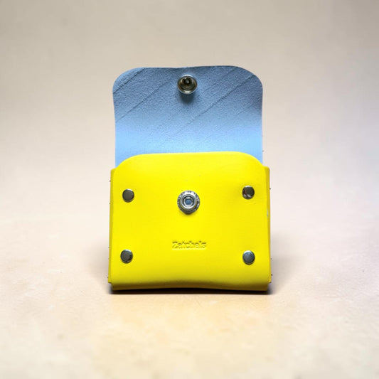 Two-layered tool holder with blue top and yellow bottom on a light gray background