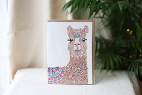  Handmade Lokta paper notebook with blue cotton fibre cover, wooden button and string tie closure, styled with a small pink blossom on a natural linen background