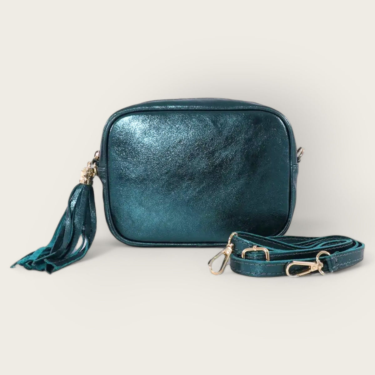 Italian leather bags: metallic teal leather camera bag with a tassel zip pull and a detachable shoulder strap