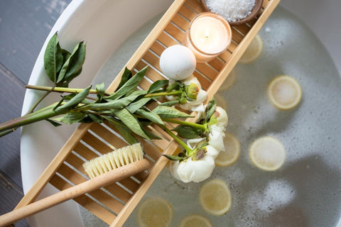  Natural bath ritual with candle, flowers, lemon slices and bath salts — Apricot Moon all‑natural Wellness Gifts.