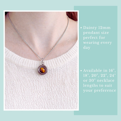 Necklace with a pendant on a person wearing a white sweater, with text about necklace length options.