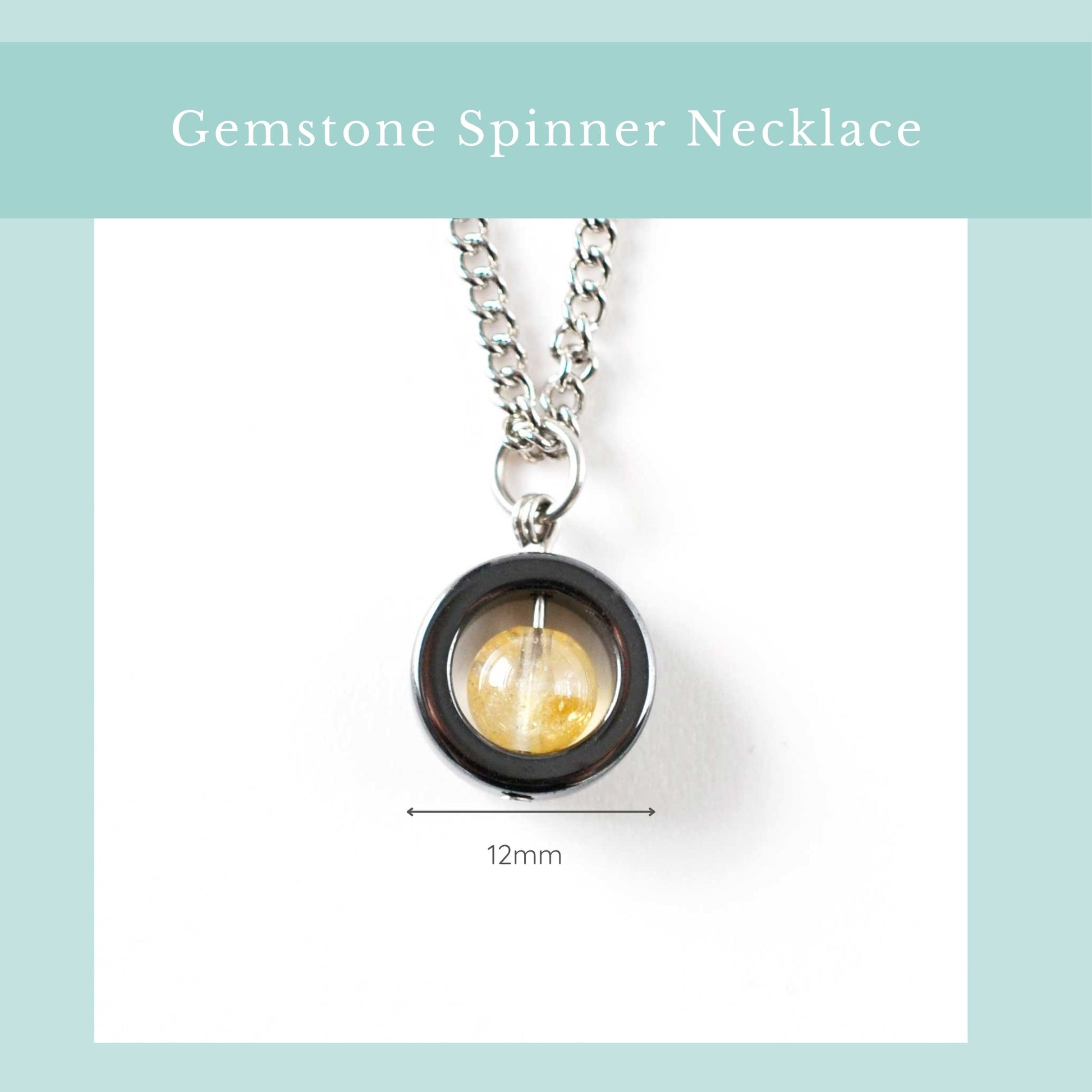 Gemstone spinner necklace with a yellow gemstone on a white background