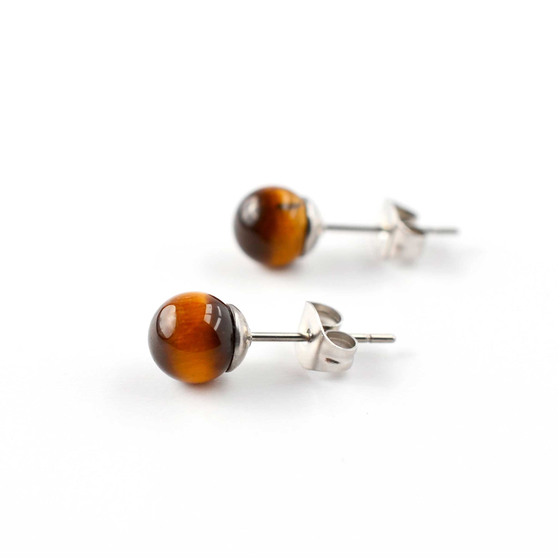 Pair of tiger eye stud earrings on a white background