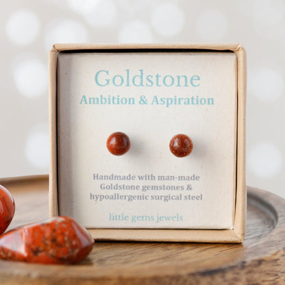 Goldstone earrings in a 'little gems jewels' box on a wooden surface