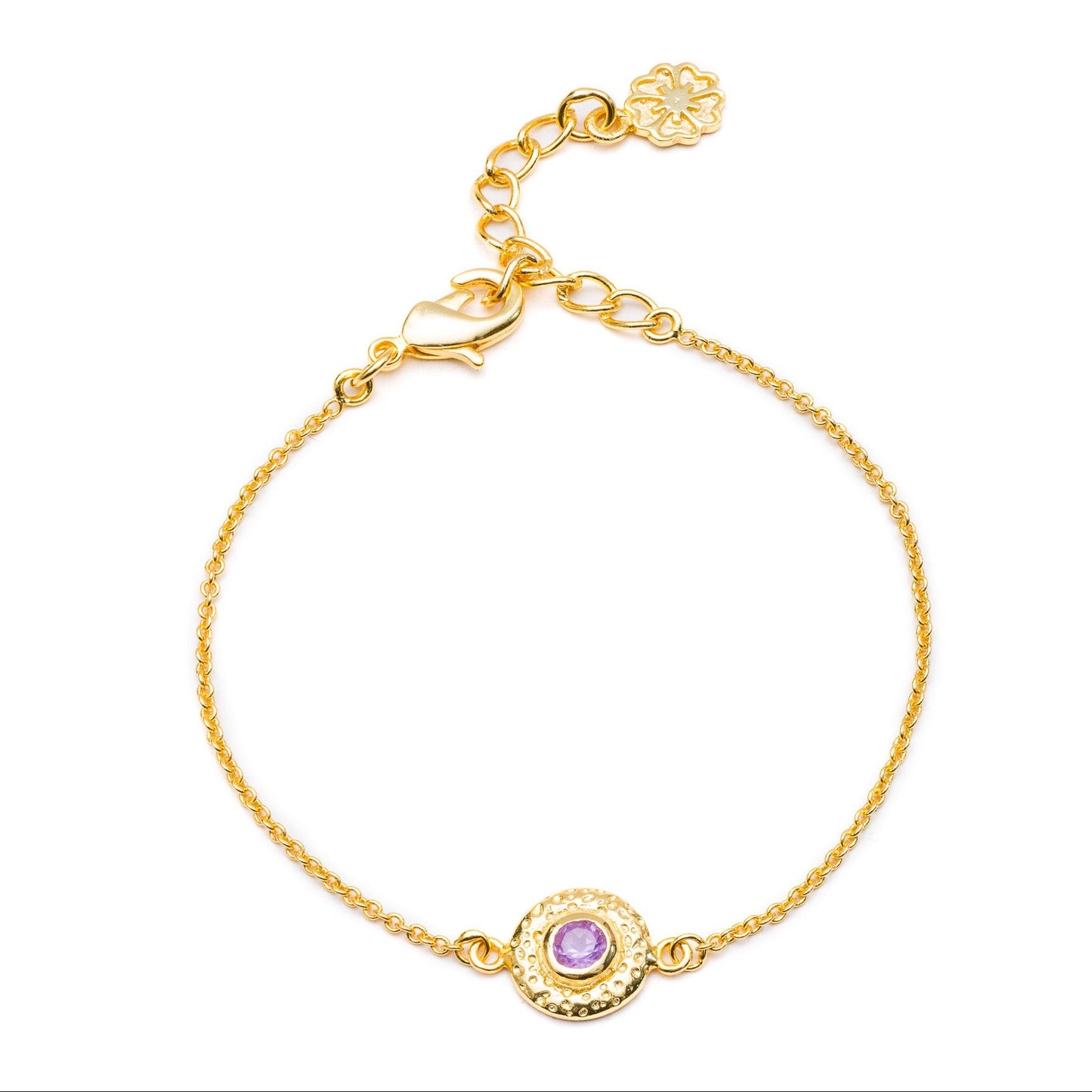 Gold bracelet with a purple gemstone on a white background