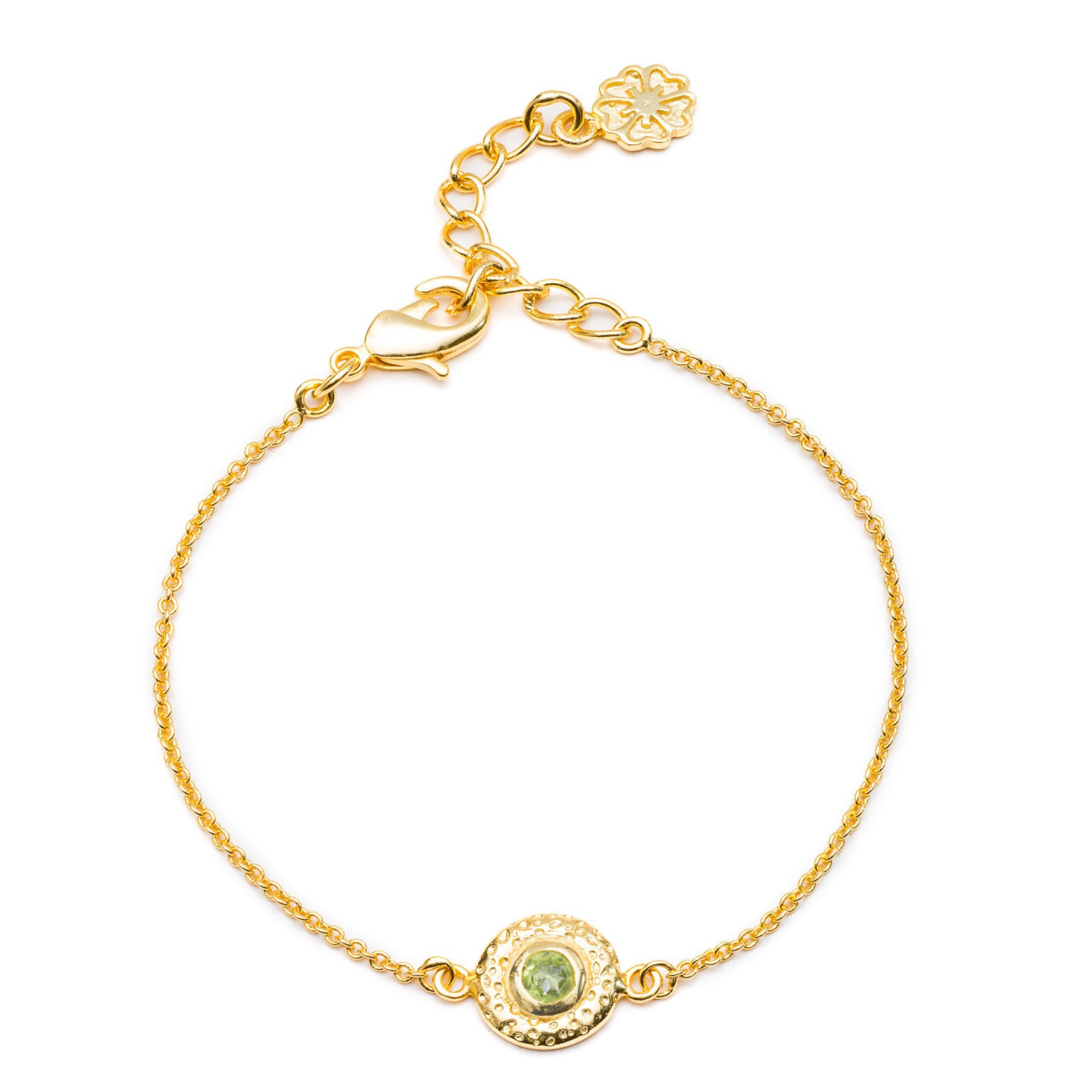 Gold bracelet with a green gemstone on a white background