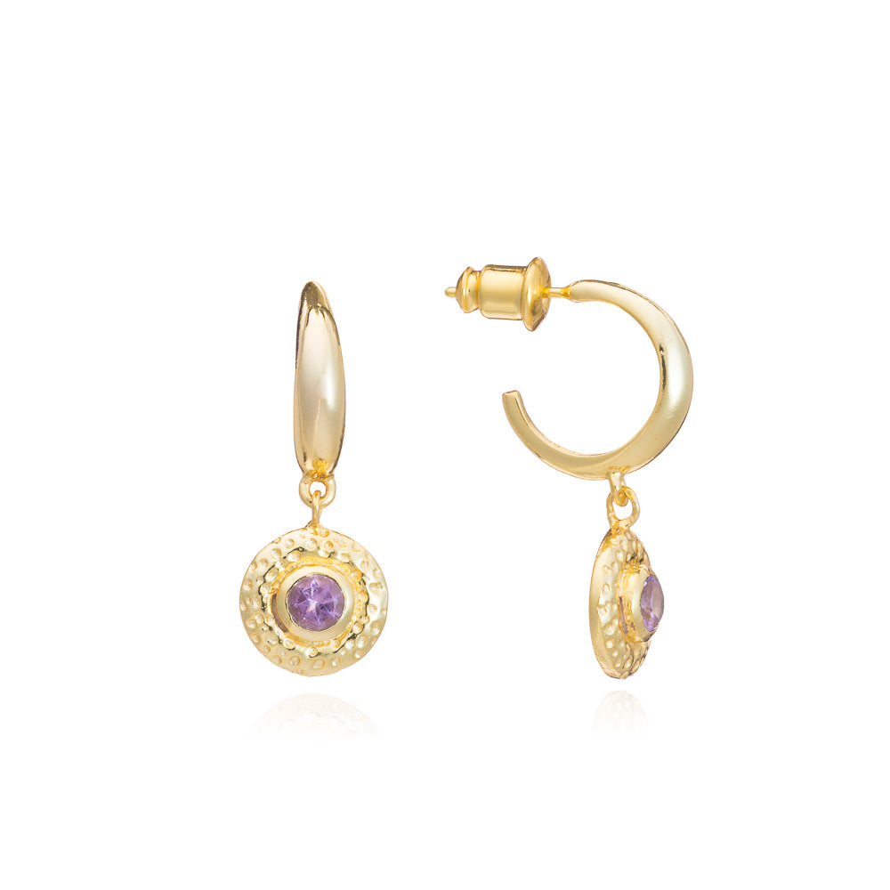 Gold hoop earrings with purple gemstones on a white background