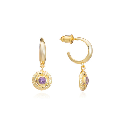 Gold hoop earrings with purple gemstones on a white background