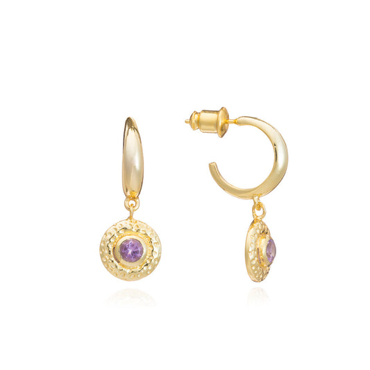 Gold hoop earrings with purple gemstones on a white background