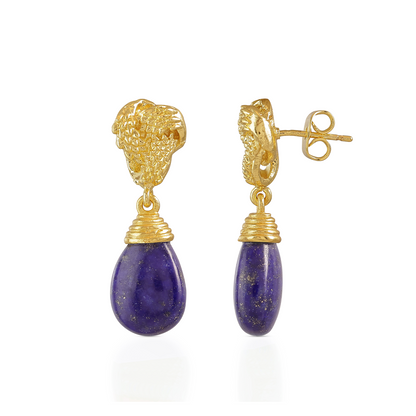 Gold earrings with purple teardrop stones on a white background