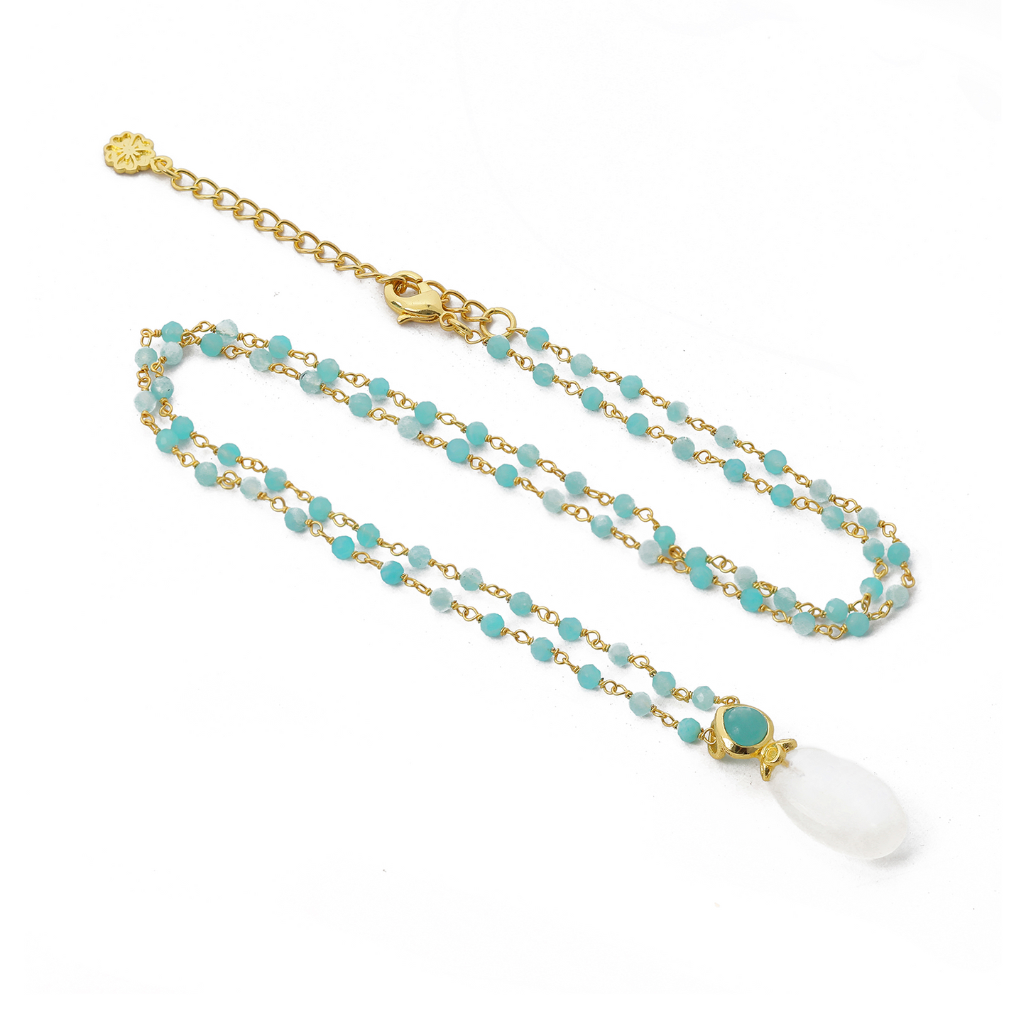 Necklace with turquoise beads and a white pendant on a white background