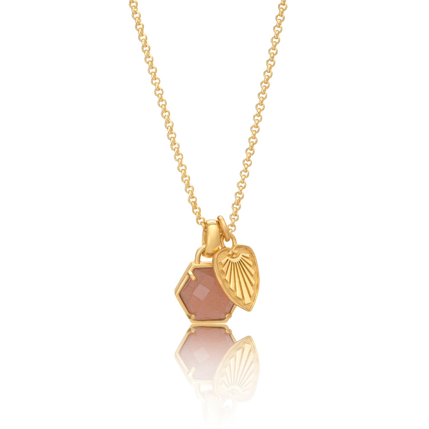 Gold necklace with a heart-shaped pendant and pink stone on a white background