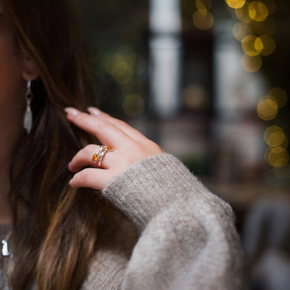 Close-up of a person wearing a ring with a blurred background