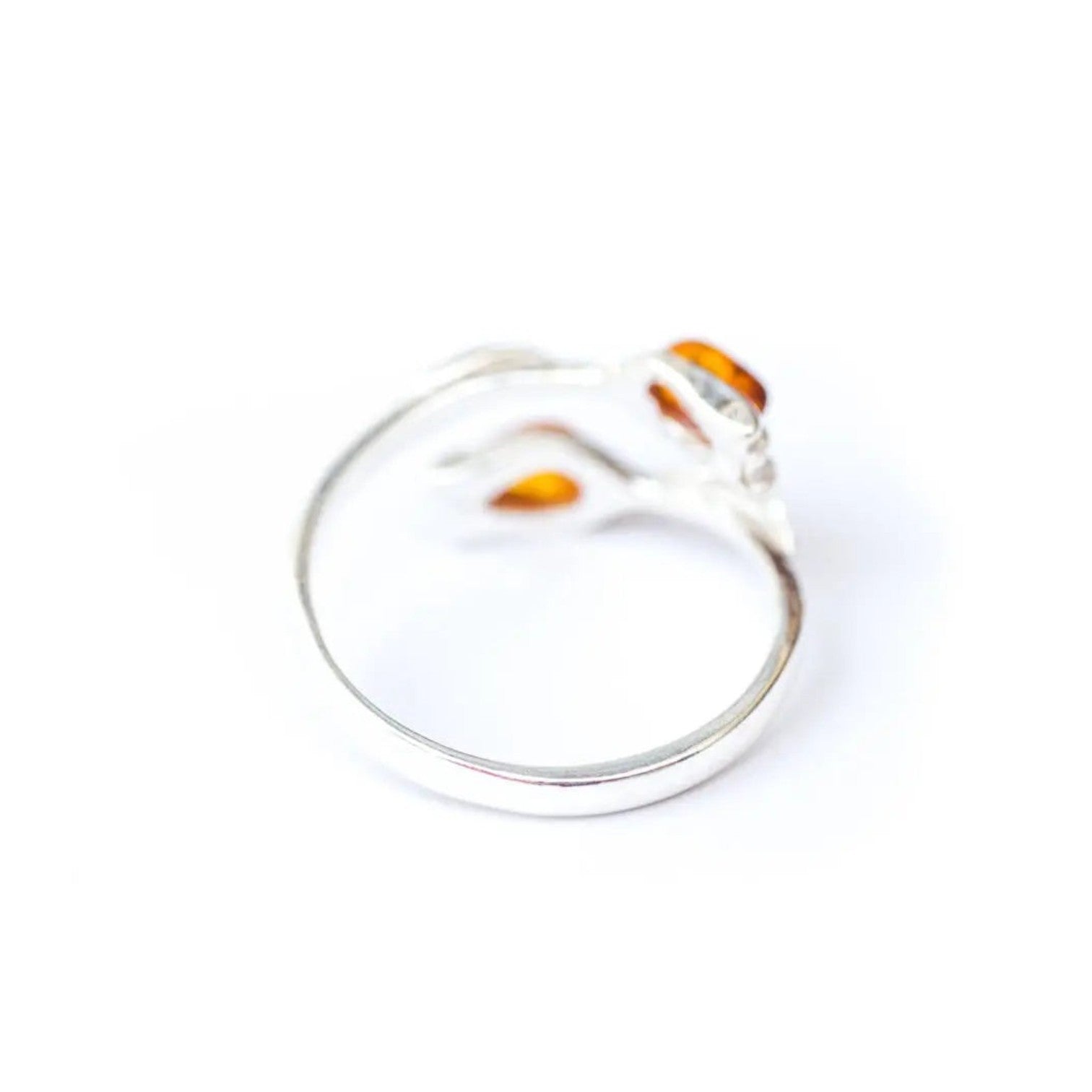 Silver ring with orange accents on a white background
