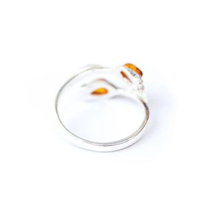 Silver ring with orange accents on a white background