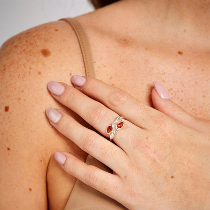 Close-up of a hand wearing a ring on a light background