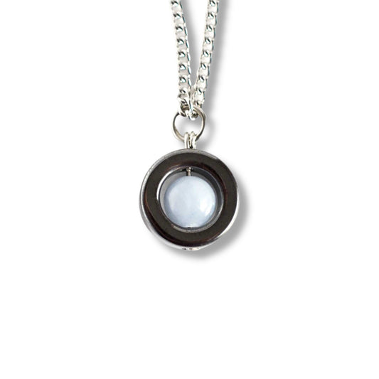 Silver necklace with a round pendant on a white background
