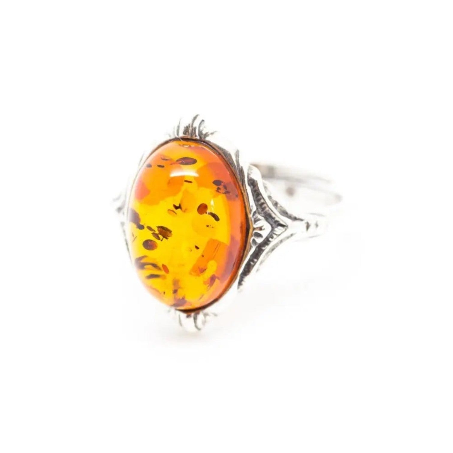 Ring with amber stone and silver band on a white background