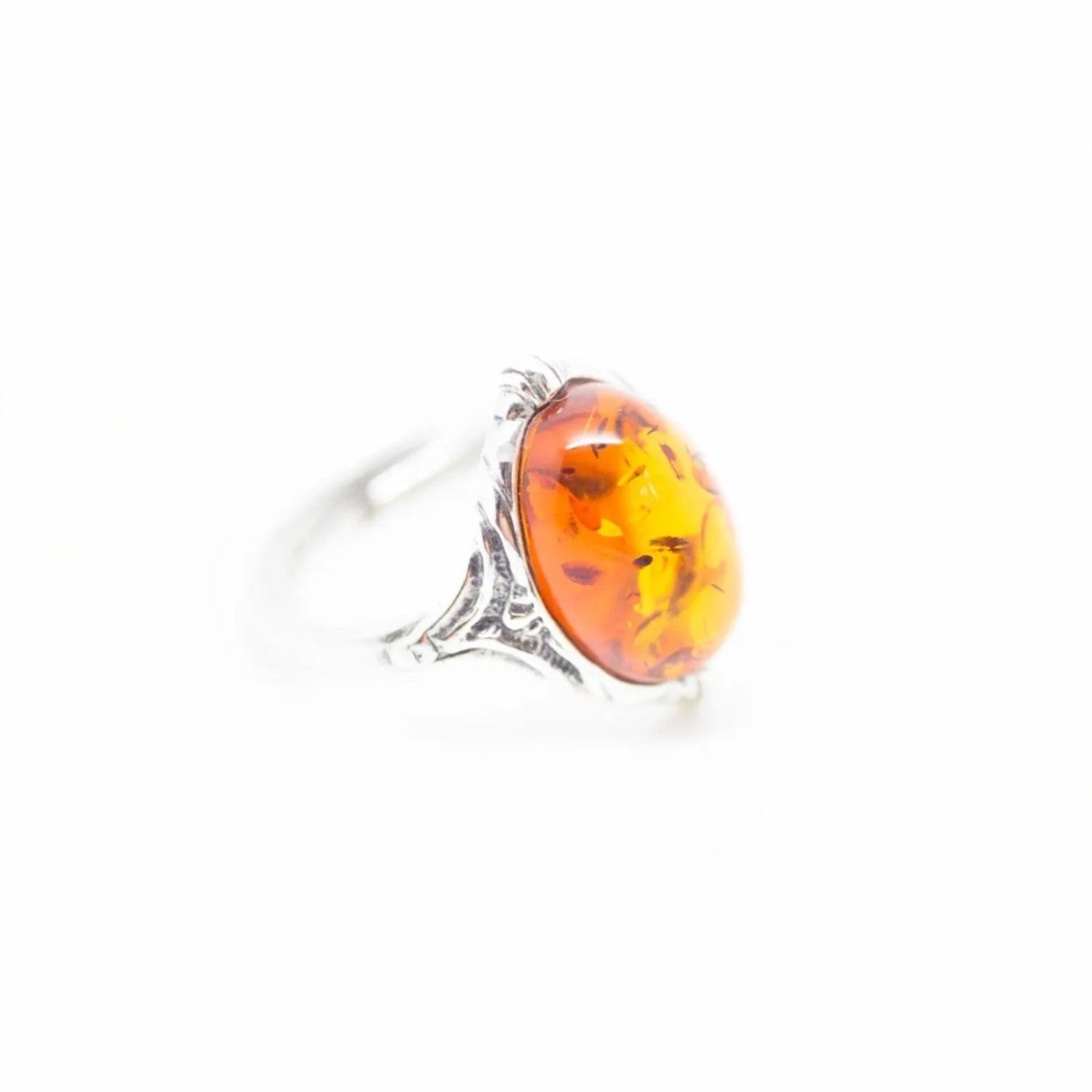 Ring with amber stone on a white background