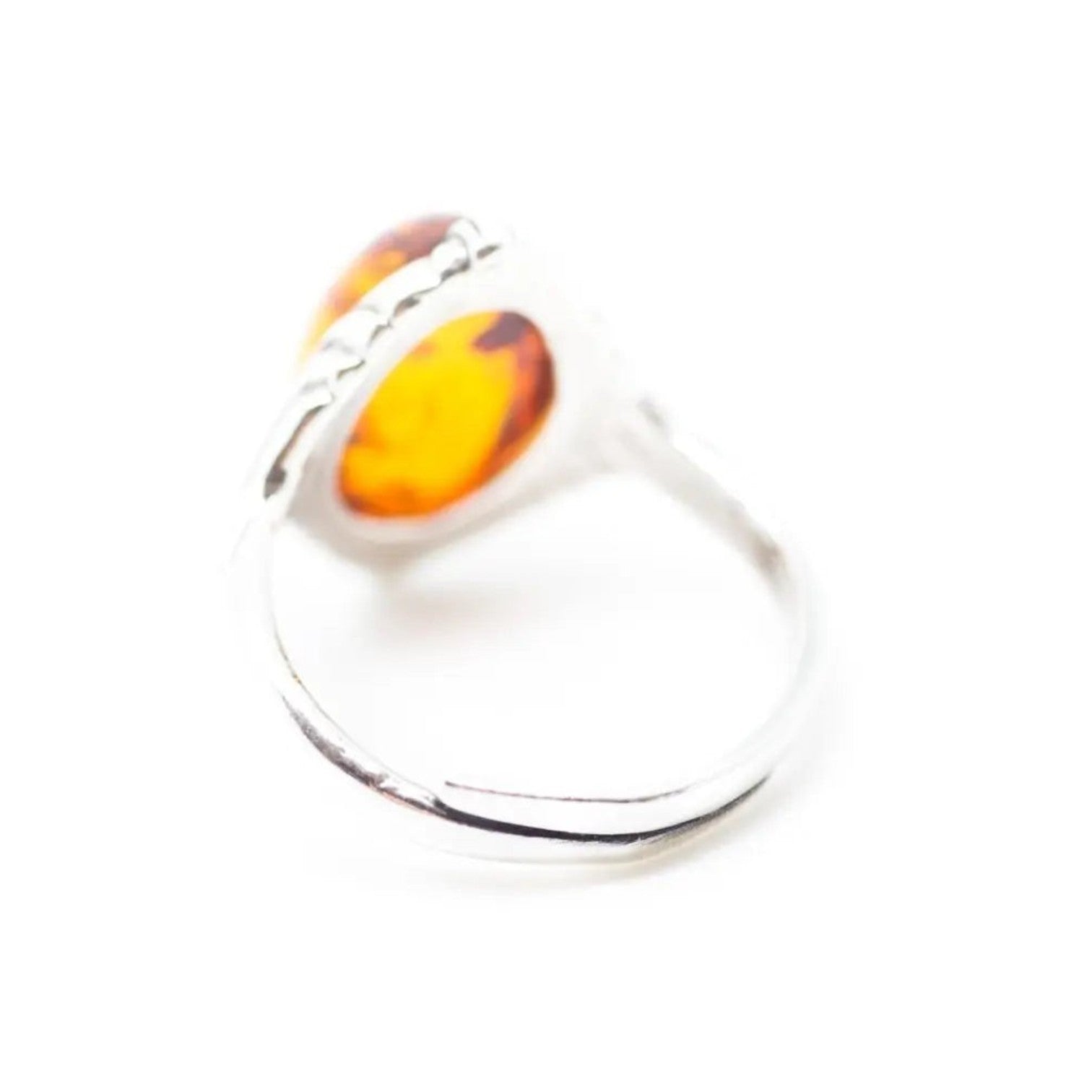 Ring with amber stone on a white background