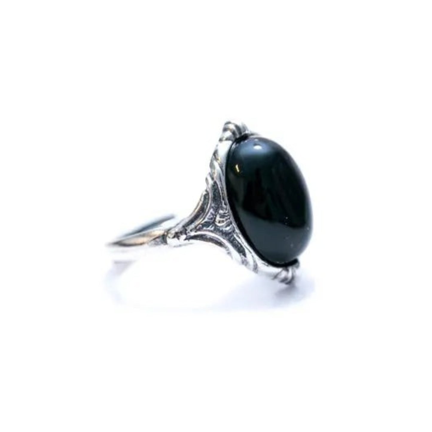 Silver ring with a large black gemstone on a white background