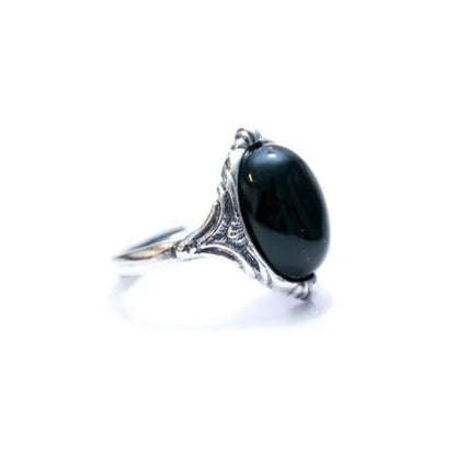 Silver ring with a large black gemstone on a white background