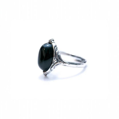 Silver ring with a black gemstone on a white background