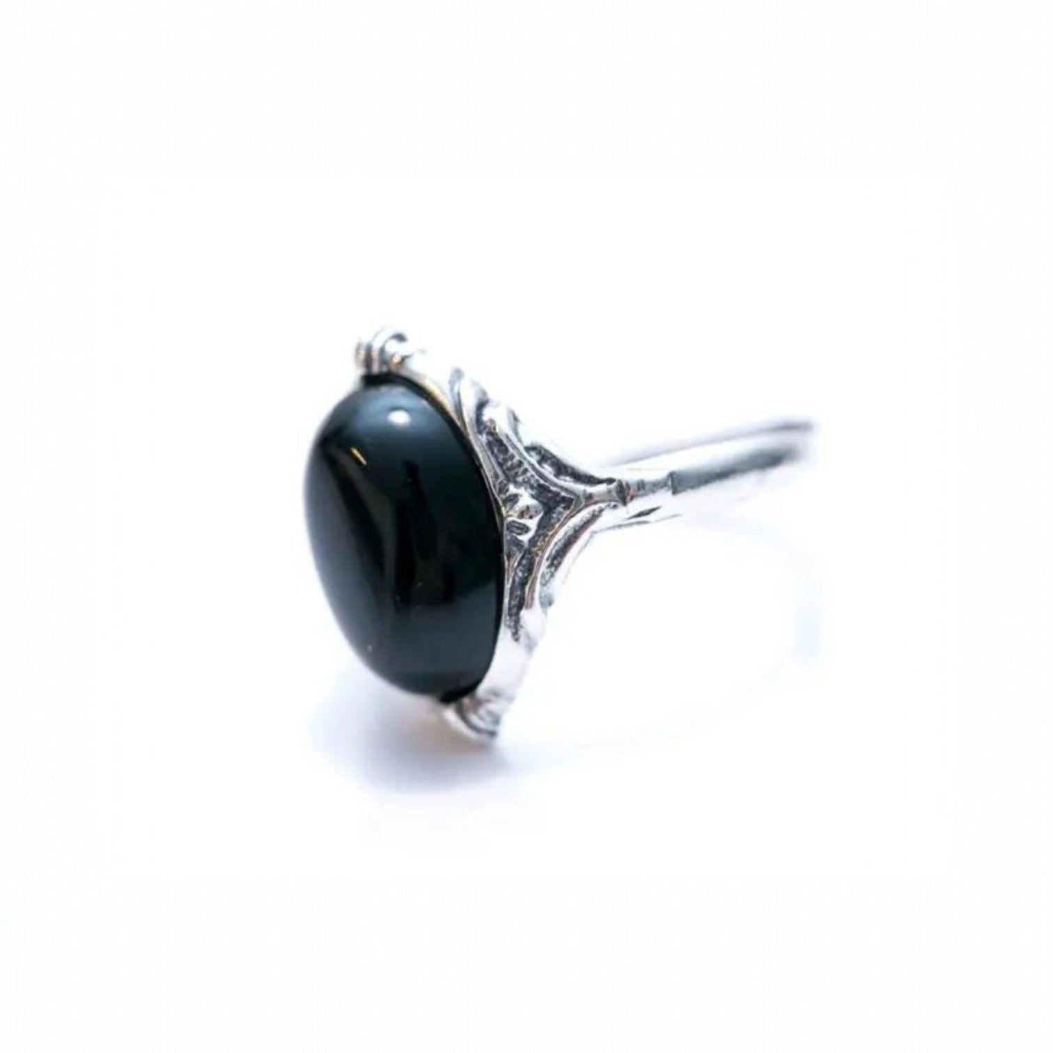Silver ring with a black gemstone on a white background