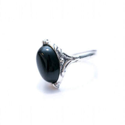 Silver ring with a black gemstone on a white background
