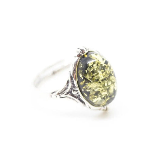 Ring with a yellow gemstone on a white background