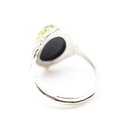 Silver ring with a black stone on a white background