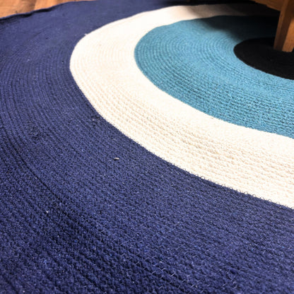 Close-up of the braided cotton rope texture on the Evil Eye Rug, showing the navy, white and turquoise rings