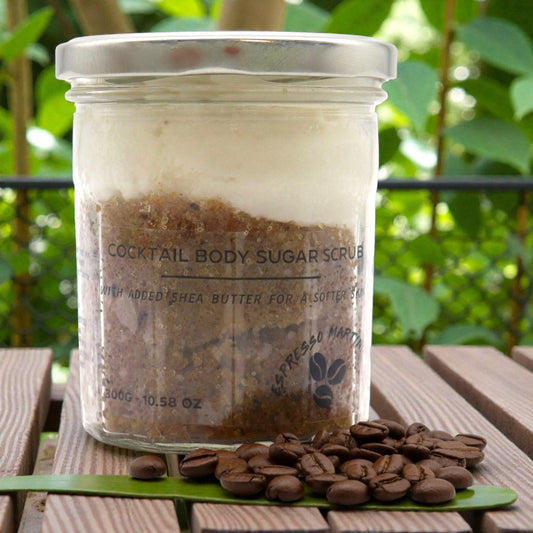Jar of cocktail body sugar scrub with coffee beans on a wooden surface