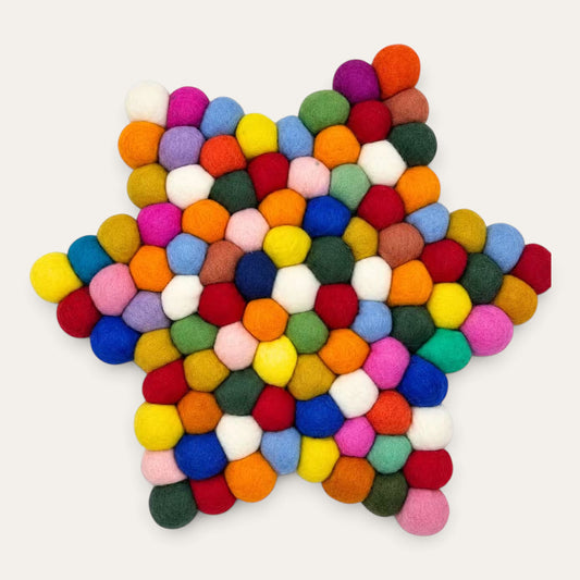 Multicolour felt ball star-shaped centre mat seen from above, in a rainbow mix of wool balls