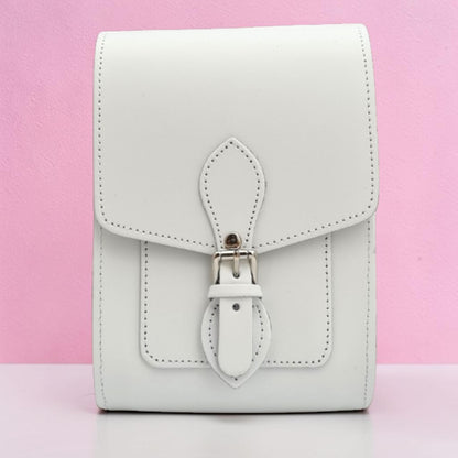 White leather wallet with a strap on a pink background