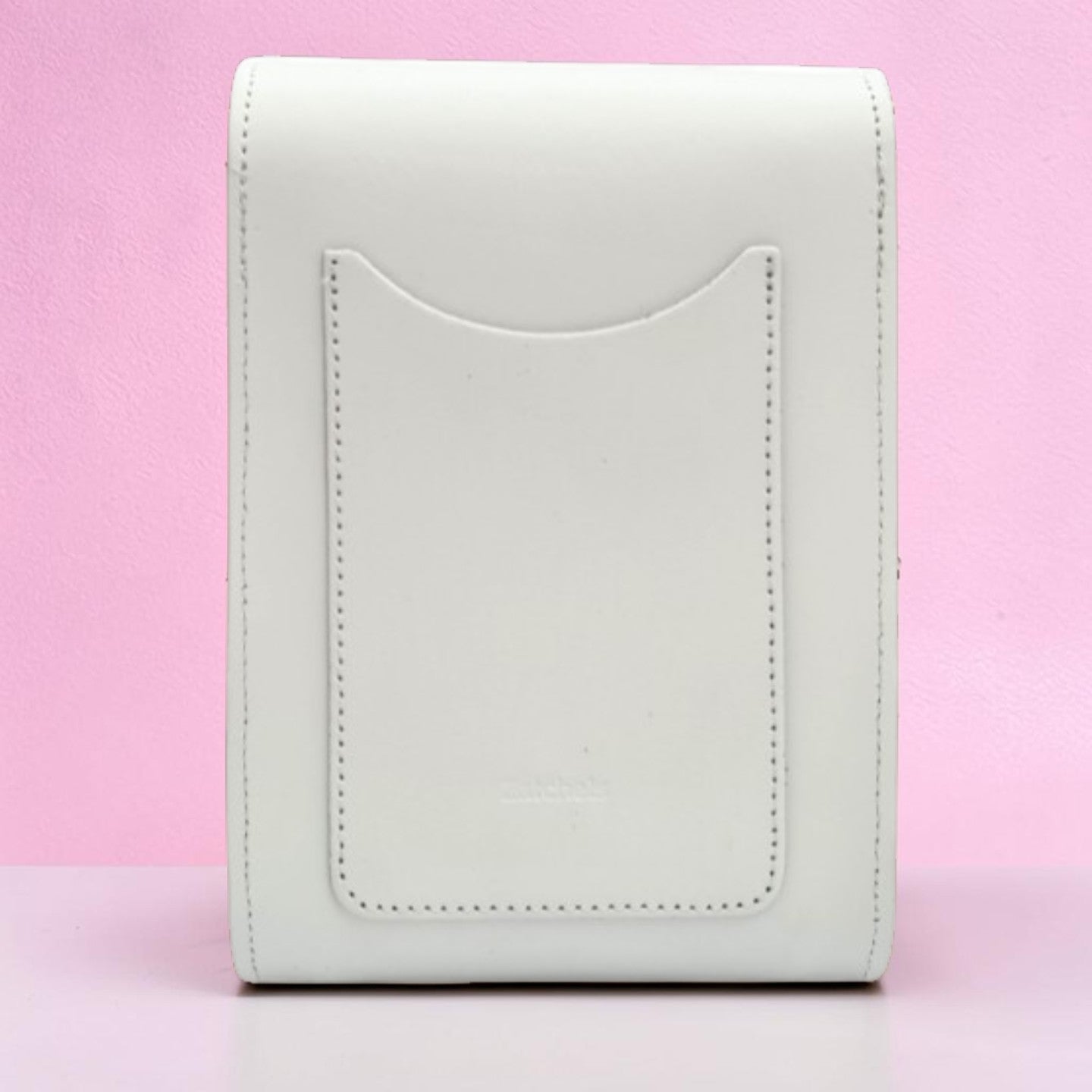 White leather wallet on a pink background