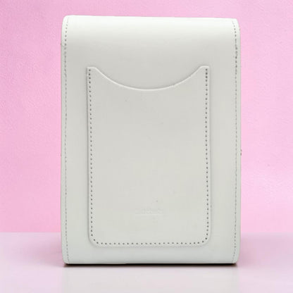 White leather wallet on a pink background