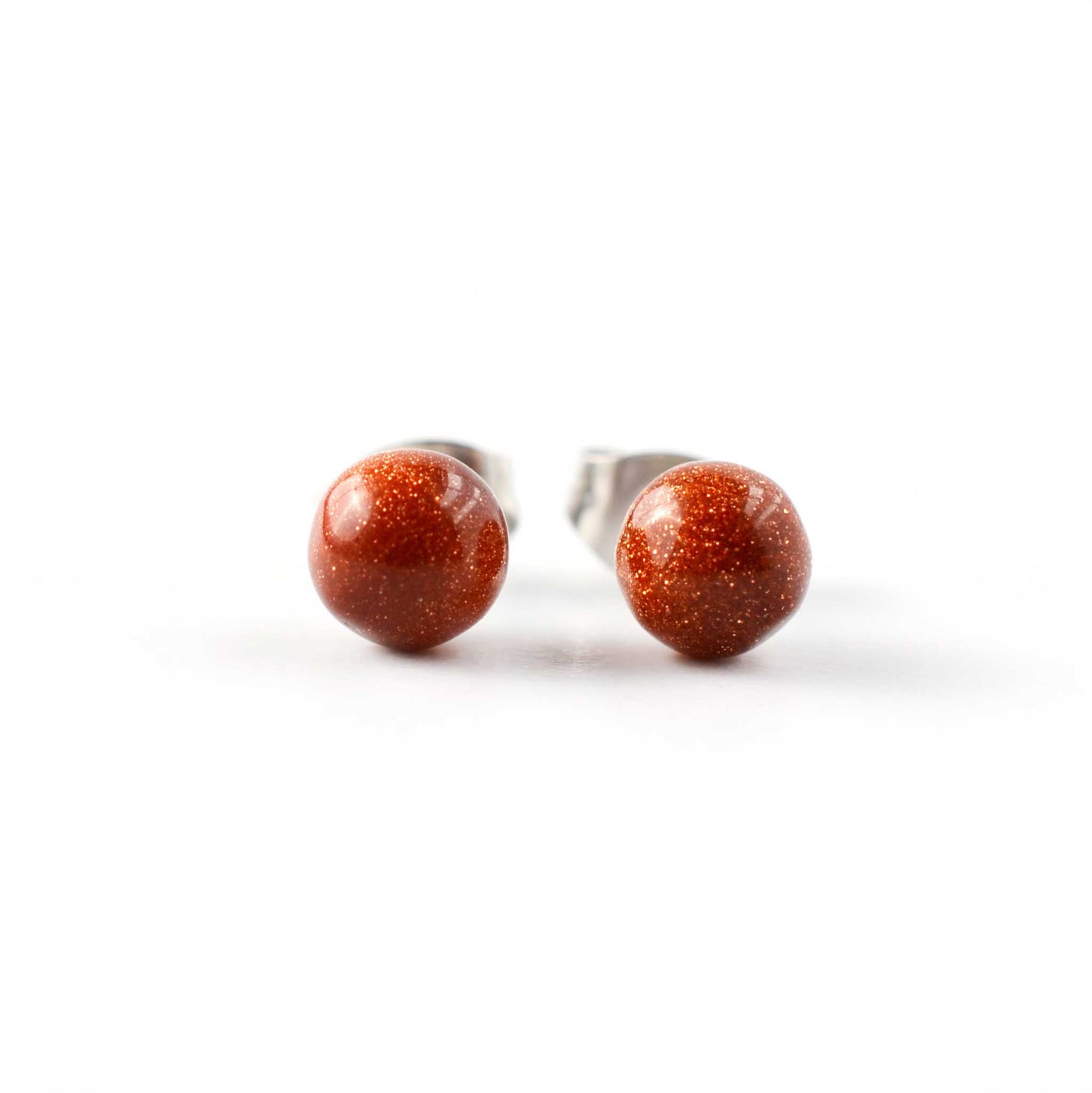 Pair of stud earrings with clear gemstones on a white background