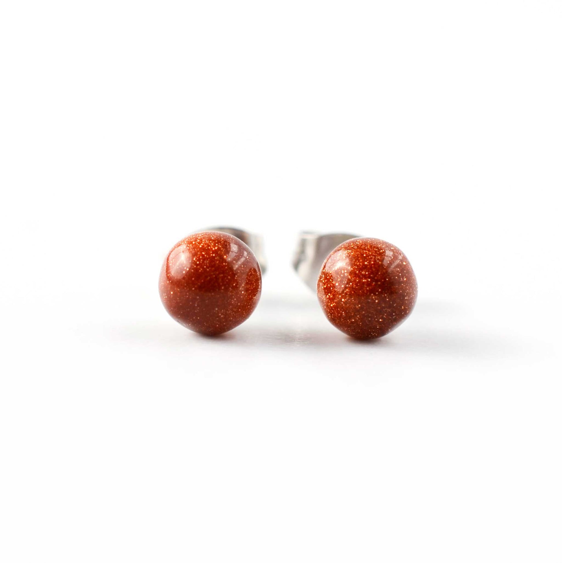 Pair of stud earrings with clear gemstones on a white background