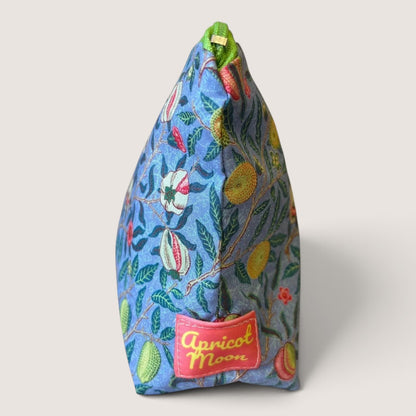 End view of the Garden Fruits everyday pouch showing the Apricot Moon label and green zip