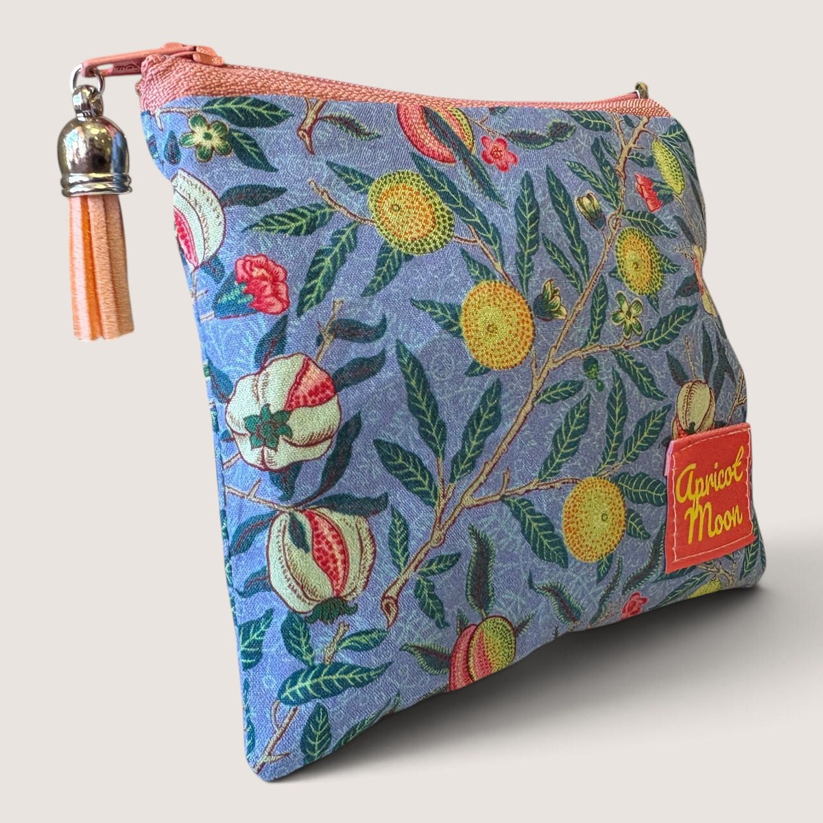 Garden Fruits purse in a blue William Morris fruit print with a pale blue zip and pale pink tassel