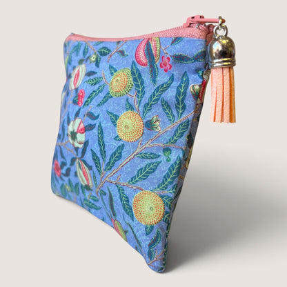 Front of the Garden Fruits purse in a William Morris fruit print with a coral zip, peach tassel and Apricot Moon label