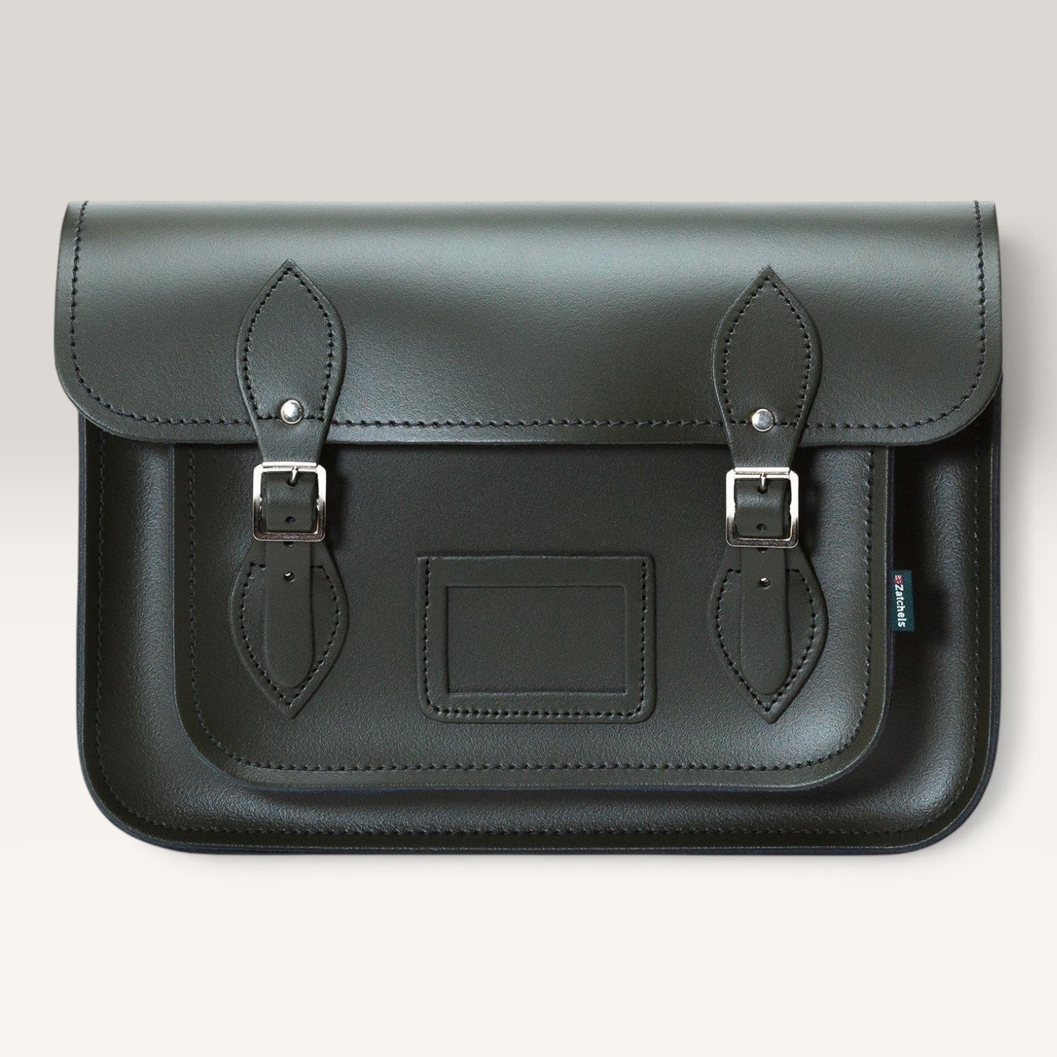 A dark green leather satchel bag with two buckle straps and silver metal hardware, shown against a light gray background.