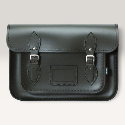 A dark green leather satchel bag with two buckle straps and silver metal hardware, shown against a light gray background.