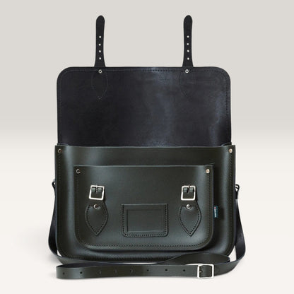 A black leather messenger bag with a front pocket, silver buckle details, and a detachable shoulder strap, shown against a neutral light gray background.
