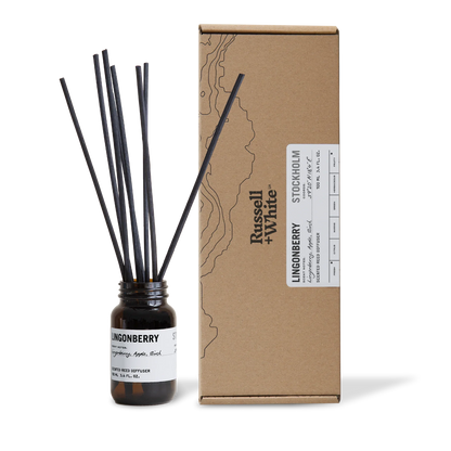Diffuser bottle with black sticks and cardboard box labeled 'Russell & White' on a white background