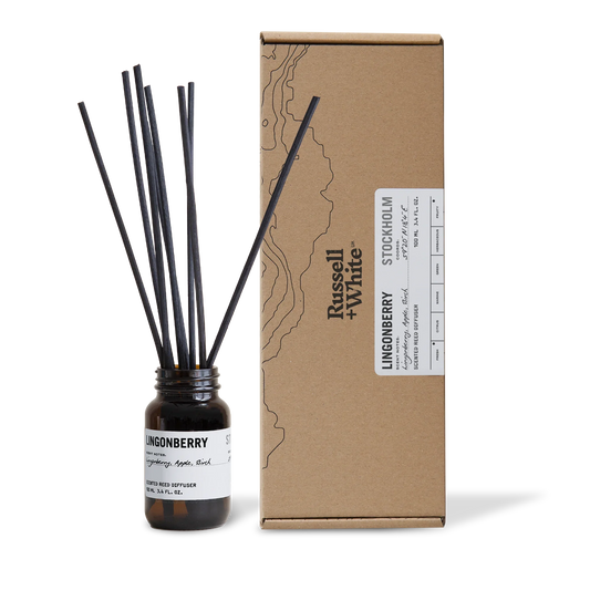 Diffuser bottle with black sticks and cardboard box labeled 'Russell & White' on a white background